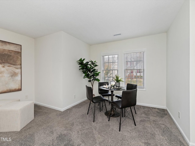 dining room featuring visible vents, baseboards, and carpet floors