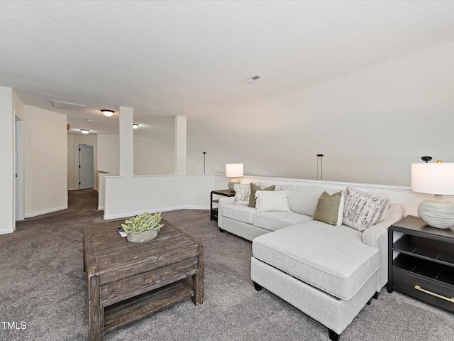 living room with baseboards, visible vents, carpet floors, and a textured ceiling