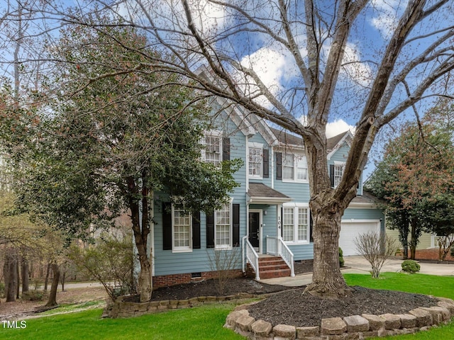 view of front of house with crawl space, a front lawn, a garage, and driveway