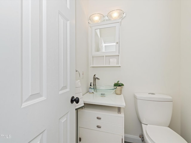 bathroom with toilet and vanity