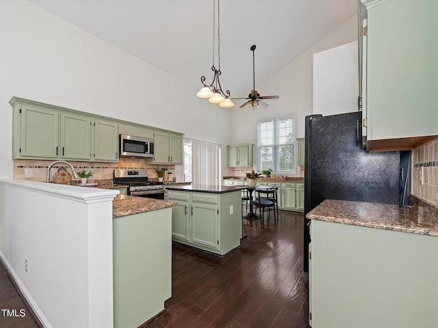 kitchen featuring high vaulted ceiling, a ceiling fan, dark wood-style floors, appliances with stainless steel finishes, and green cabinets