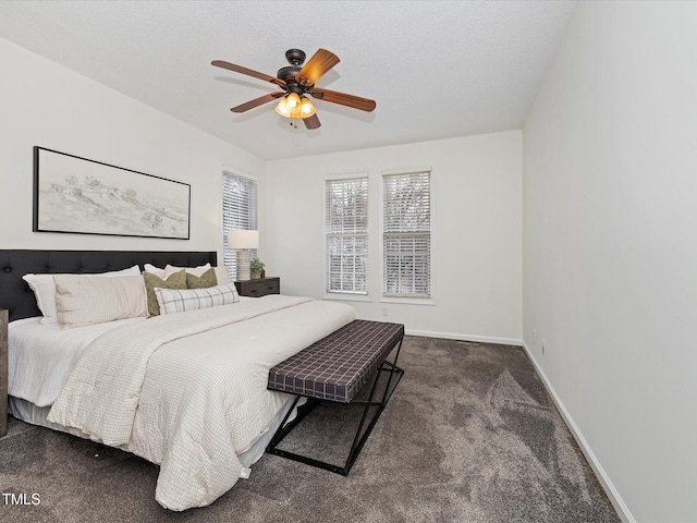 carpeted bedroom with baseboards, a textured ceiling, and a ceiling fan