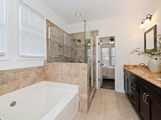 ensuite bathroom with a sink, tile patterned flooring, a shower stall, a bath, and connected bathroom