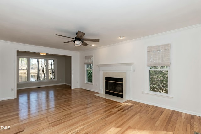 unfurnished living room with light wood-style floors, a healthy amount of sunlight, and a fireplace