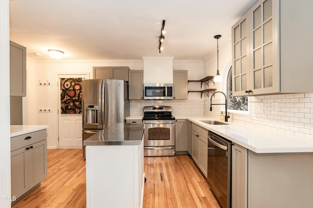 kitchen featuring a sink, stainless steel appliances, light wood-style floors, and gray cabinetry