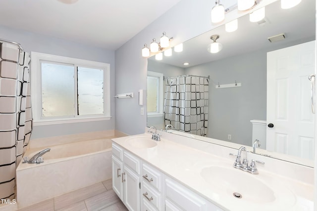 full bathroom with a garden tub, double vanity, visible vents, and a sink