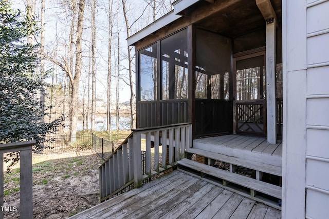 wooden deck featuring fence and a sunroom