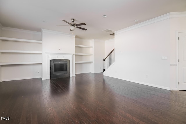 unfurnished living room featuring wood finished floors, baseboards, ceiling fan, a glass covered fireplace, and crown molding