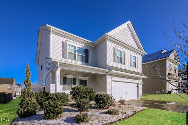 view of front of property with driveway, a front yard, and an attached garage