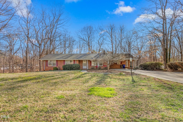 ranch-style house with a carport, a front lawn, brick siding, and driveway