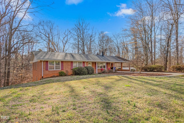 ranch-style house featuring brick siding and a front lawn