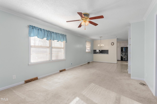 unfurnished living room featuring ceiling fan with notable chandelier, light colored carpet, visible vents, and ornamental molding