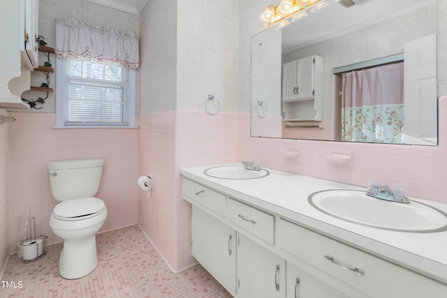 full bathroom featuring a sink, toilet, tile walls, and double vanity