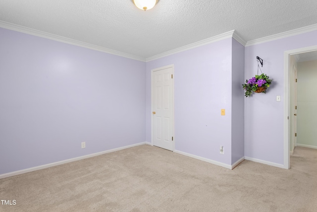 carpeted spare room featuring a textured ceiling, crown molding, and baseboards
