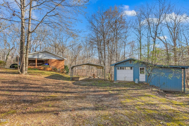 view of yard with a detached carport and an outdoor structure