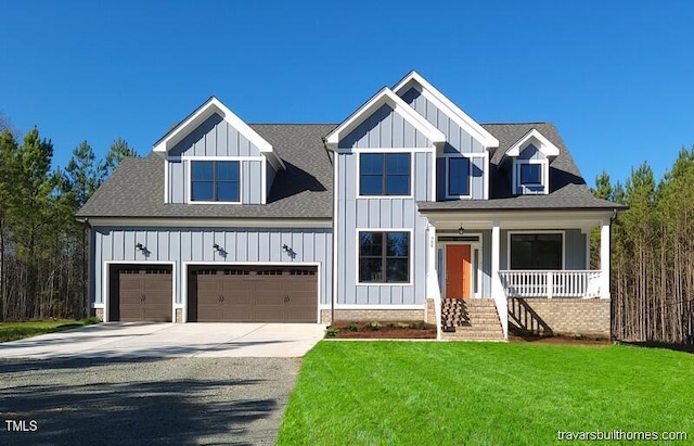 modern inspired farmhouse with a front lawn, covered porch, board and batten siding, and driveway