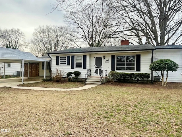 ranch-style house with an attached carport, concrete driveway, a front yard, and a chimney