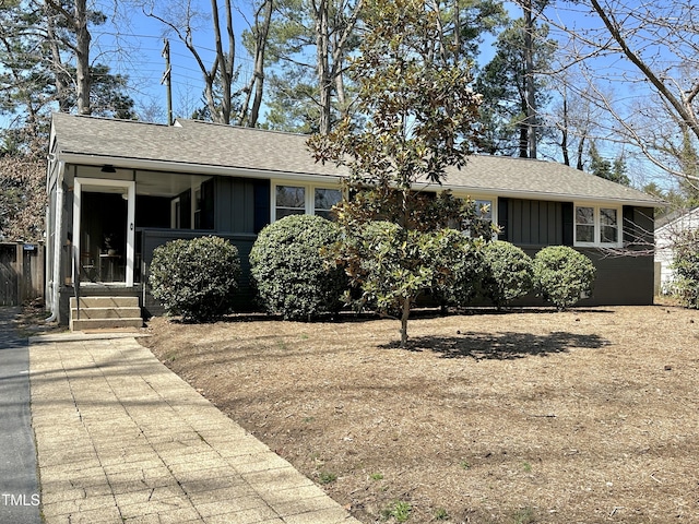 single story home featuring roof with shingles and board and batten siding