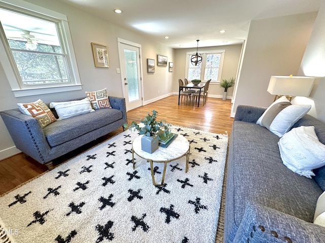 living room with recessed lighting, wood finished floors, and baseboards