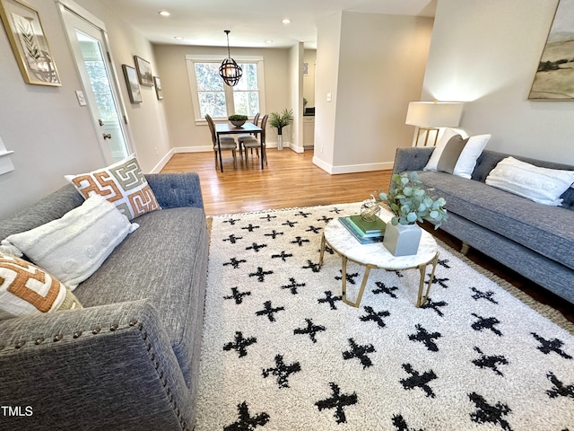 living room with recessed lighting, baseboards, and wood finished floors