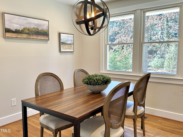 dining room with light wood-style flooring and baseboards