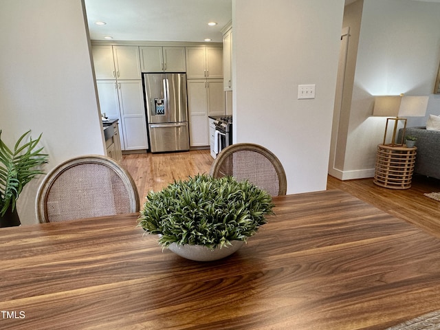 dining room featuring recessed lighting and light wood-style flooring