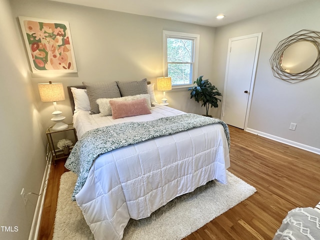 bedroom featuring recessed lighting, baseboards, and wood finished floors