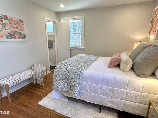 bedroom with recessed lighting and wood finished floors