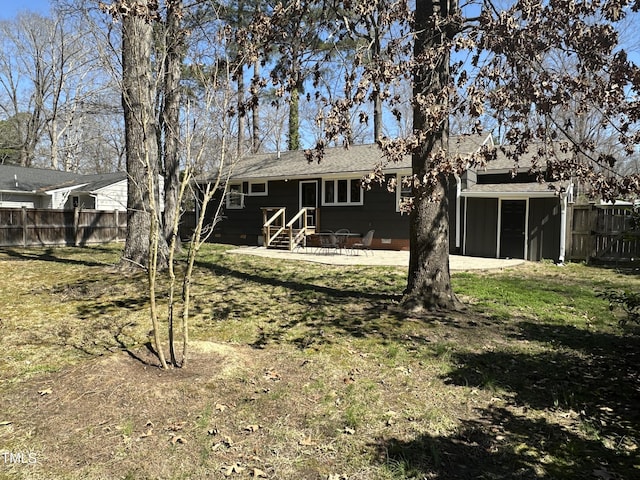 rear view of house featuring fence, a yard, entry steps, crawl space, and a patio area