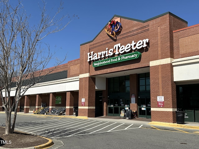 view of building exterior featuring uncovered parking