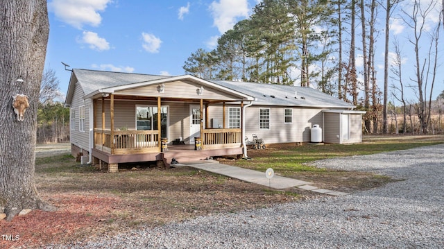 view of front of property featuring covered porch and a shingled roof