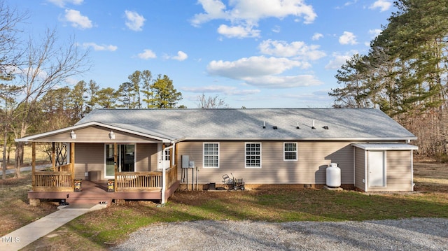 view of front facade with roof with shingles and crawl space