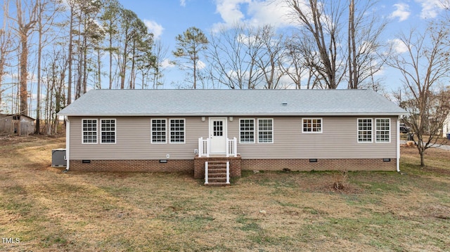 view of front of house with a front lawn, roof with shingles, central AC, and crawl space