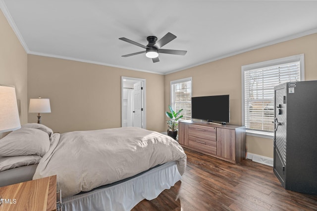 bedroom with connected bathroom, dark wood-type flooring, ceiling fan, baseboards, and ornamental molding