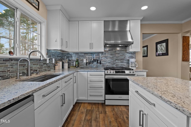 kitchen with dishwashing machine, a sink, stainless steel range with electric cooktop, crown molding, and wall chimney range hood