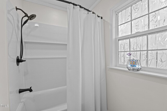 full bathroom with crown molding and shower / bath combo with shower curtain