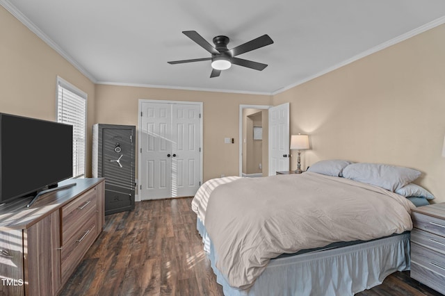 bedroom with a closet, dark wood-style floors, a ceiling fan, and ornamental molding