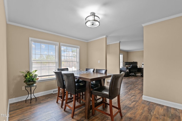 dining area featuring baseboards, dark wood-style floors, and crown molding