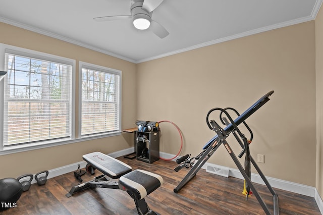 workout room featuring visible vents, crown molding, baseboards, and wood finished floors