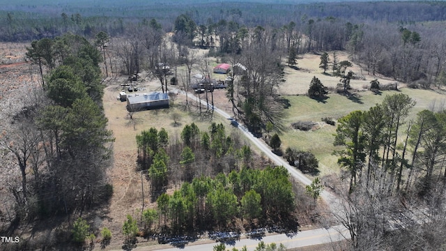 birds eye view of property featuring a rural view and a view of trees