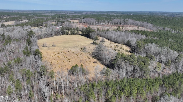 drone / aerial view with a wooded view