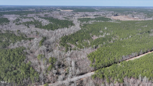 birds eye view of property featuring a view of trees