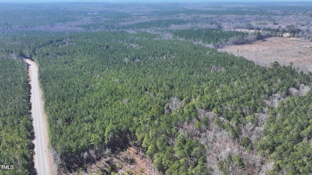 birds eye view of property featuring a forest view