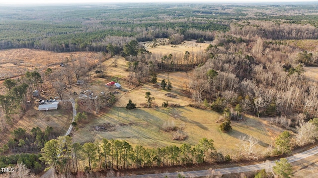 aerial view featuring a rural view and a wooded view