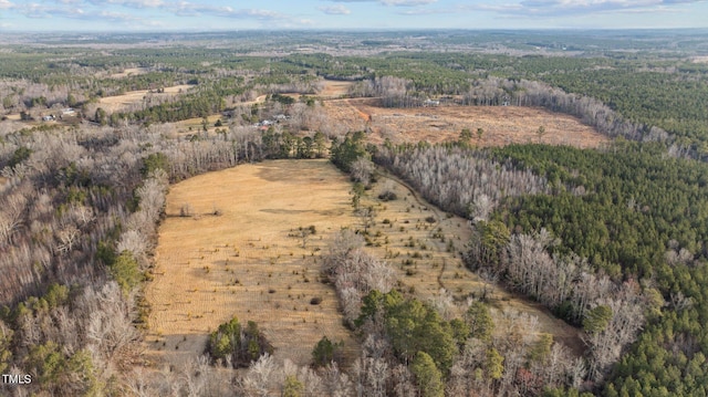 birds eye view of property with a view of trees