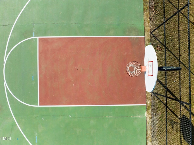 view of basketball court with community basketball court and fence