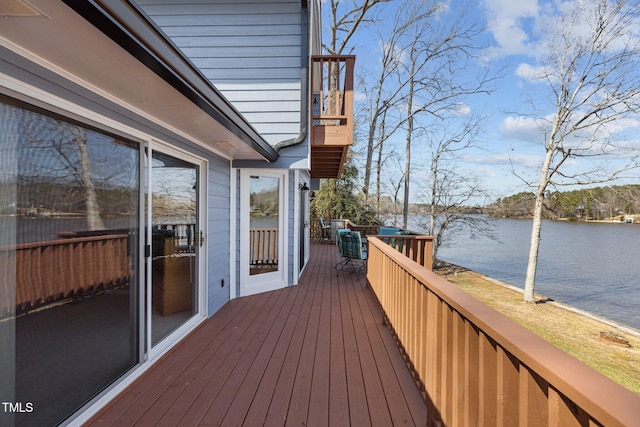 wooden deck featuring a water view