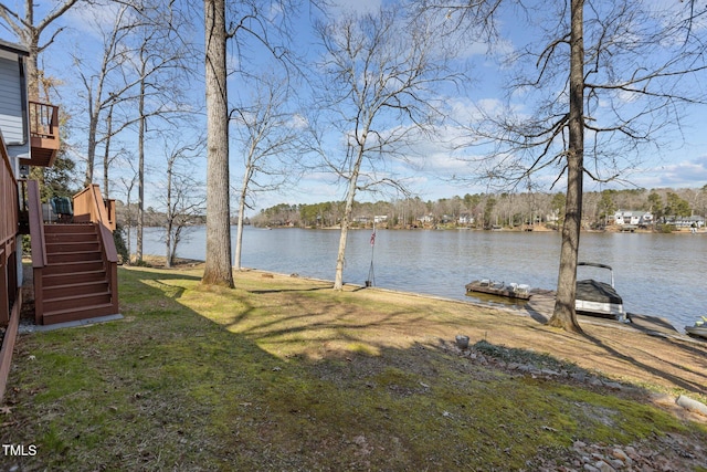 view of yard with stairway and a water view