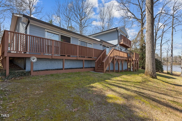 back of house with a lawn, stairs, and a deck