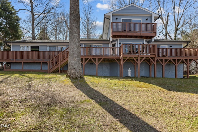 rear view of house featuring a wooden deck and a yard